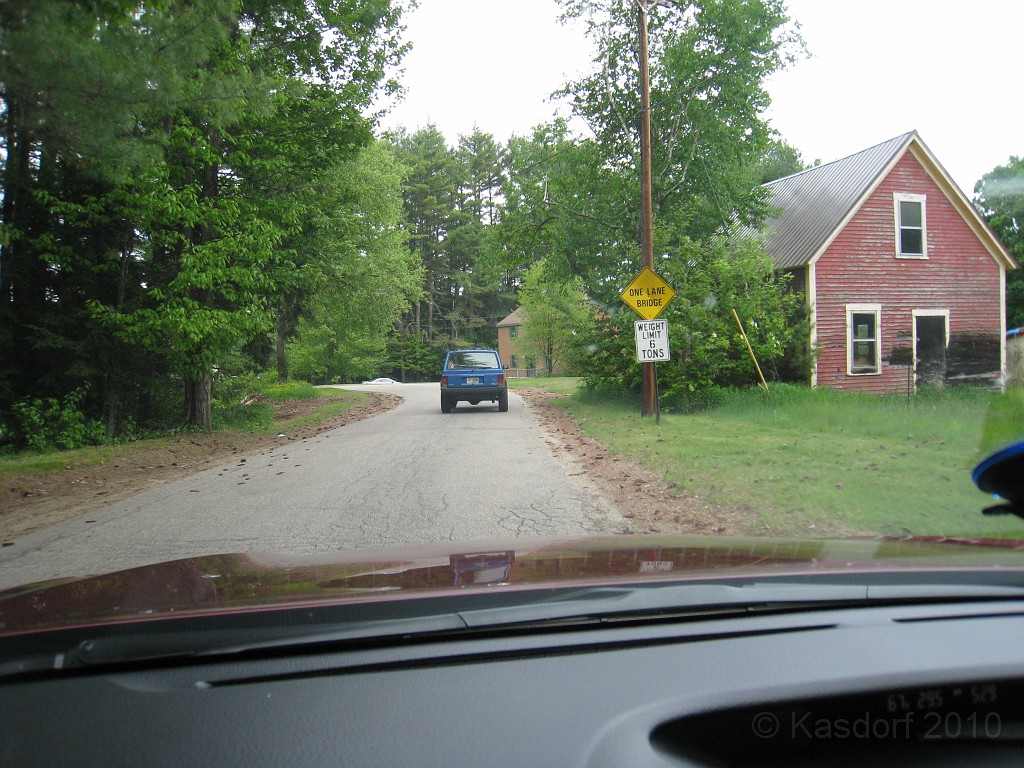 Old Hill Village - Profile Falls 020.jpg - This road is getting a little smaller...In February 1937, residents of Hill Village NH learned that their village, near the Pemigewasset River, was to become a flood control reservoir for the Franklin Falls dam project. To accommodate the construction of the Franklin Falls Dam, the village of Hill NH was to be relocated. By January of 1940, the citizens of Hill NH formed an association, purchased land, and began planning a new model village with the help of the NH State Planning and Development Commission. Construction started in 1940, and by June of 1941 the new town hall and school were completed, along with the streets, water system, and 30 houses. The 1941 town meeting was called to order in the old town hall, recessed, and reconvened in the new village.